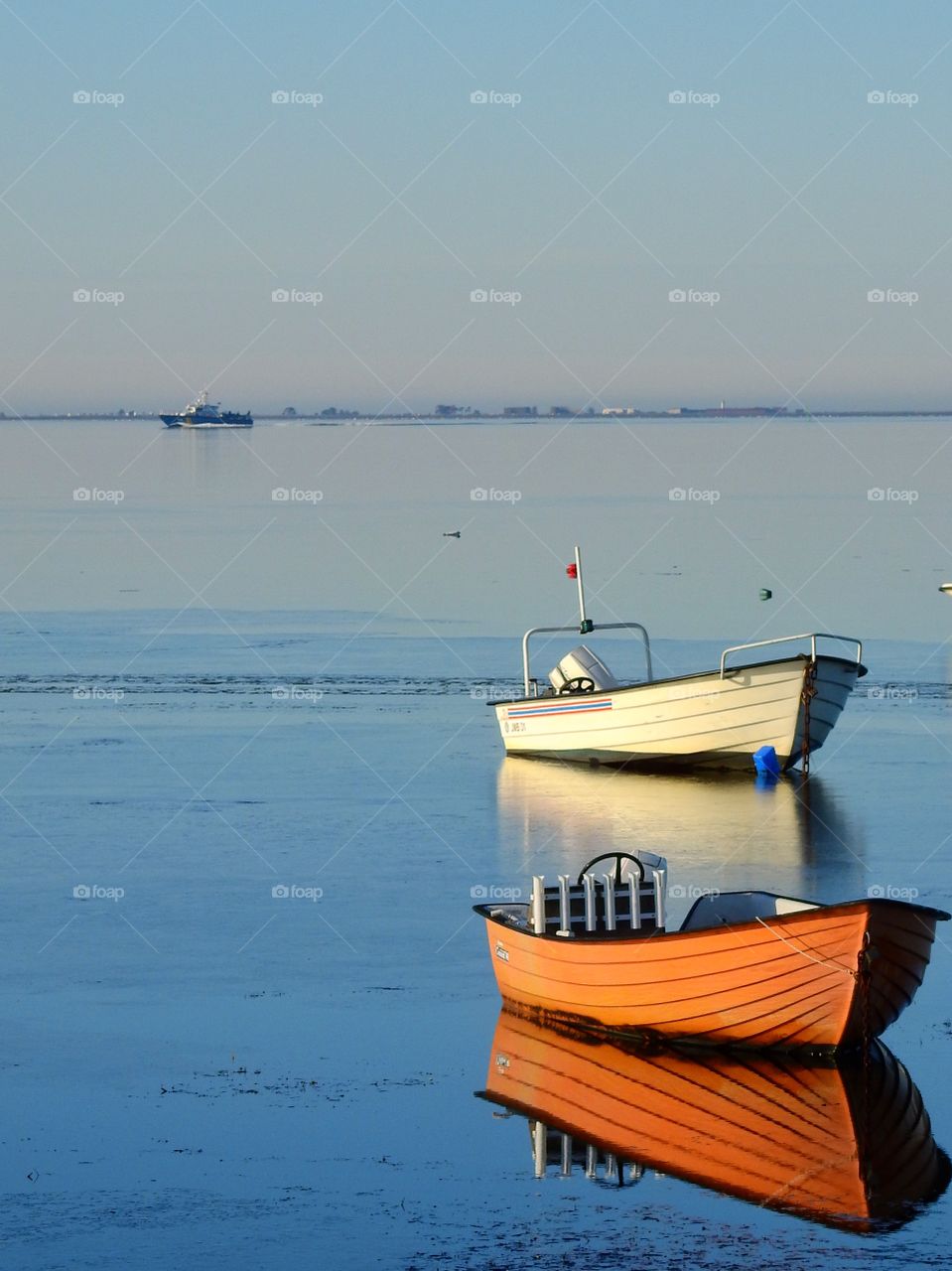 Reflection of boats in sea