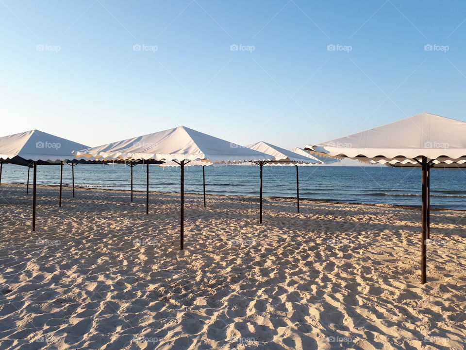 Sun umbrellas at the sand beach