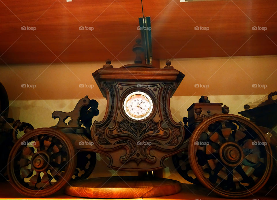 Clock.  Wooden body in the form of a carriage