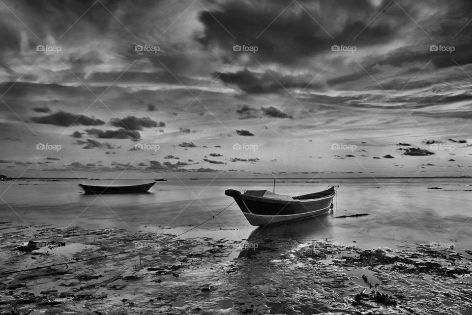 Sunset in B&W, boat at Batakan beach, South Kalimantan, Indonesia.