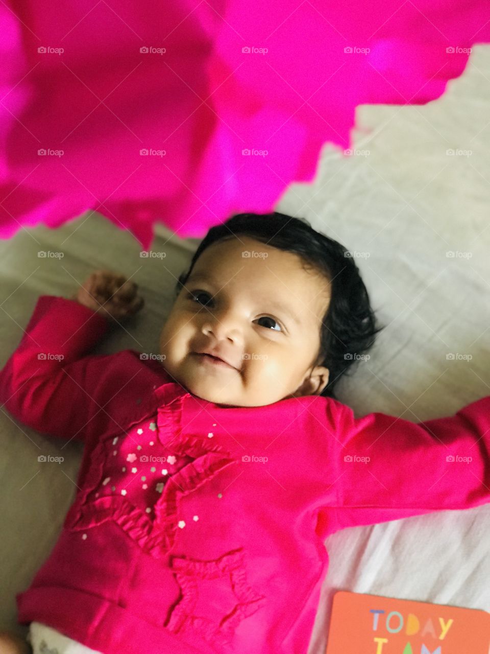 New born baby in graceful pink colour dress