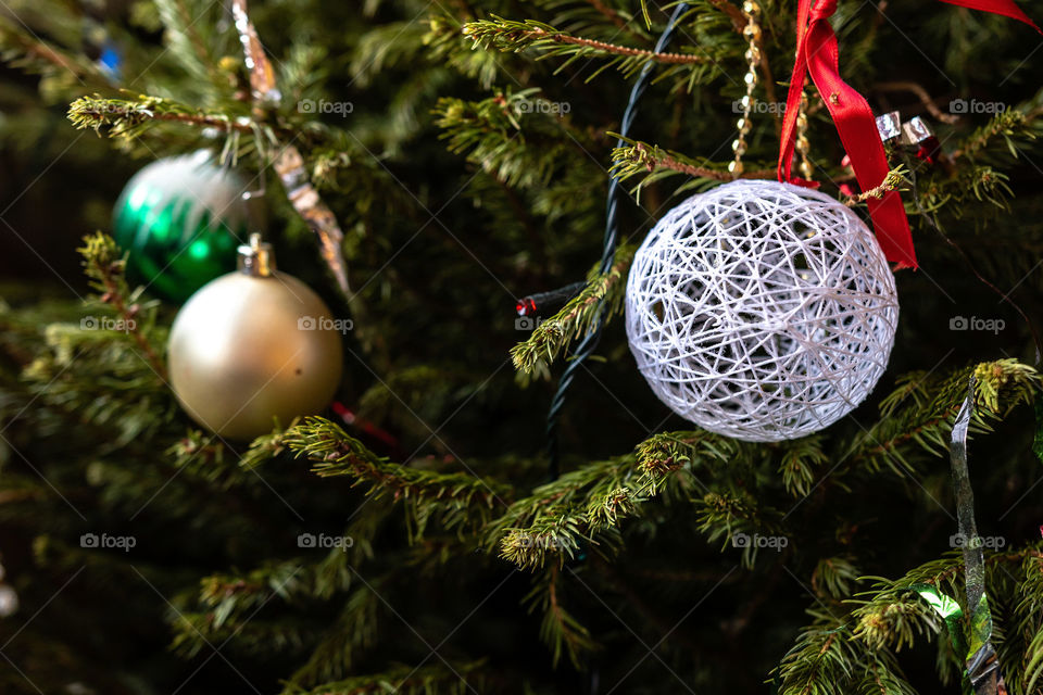 Various colorful Christmas decorations hanged spruce branches