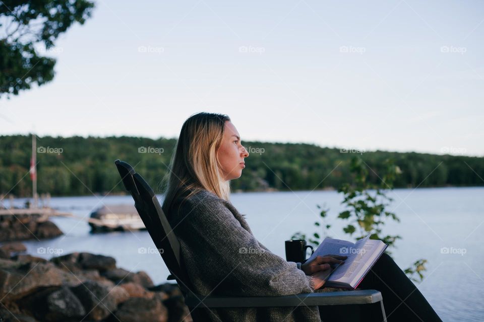 girl reading books in nature