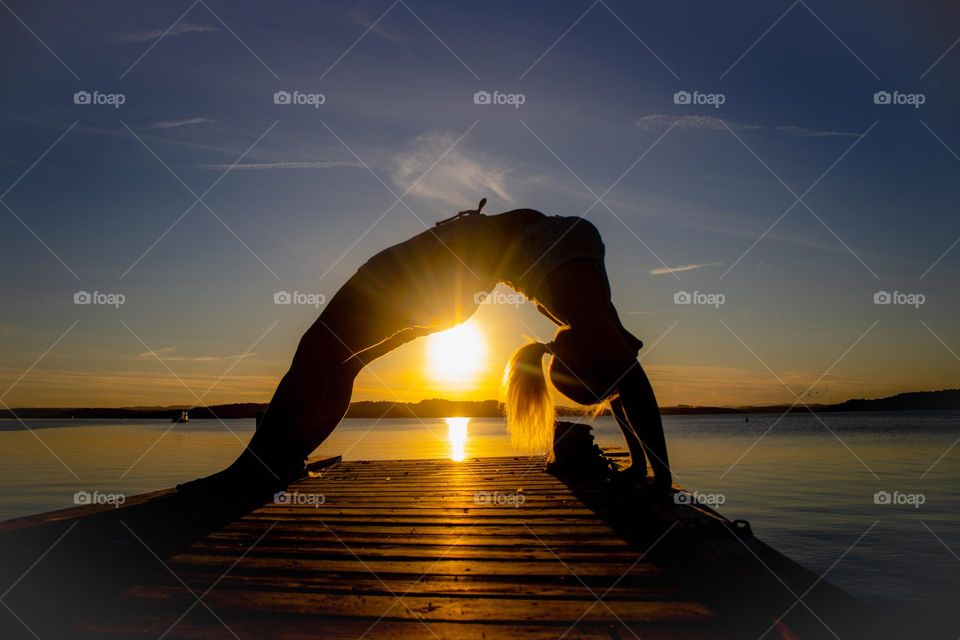 Yoga in the sun light and sunset .
Healthy woman springtime in Norway .I live the good weather.