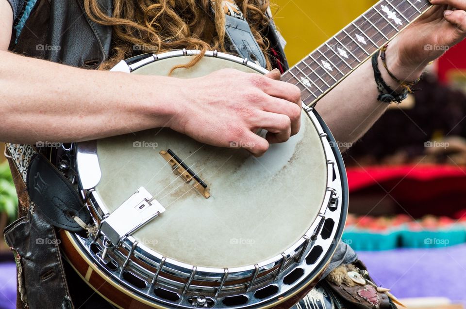 Banjo player at the farmer. Close up of a banjo player's hands playing the banjo at the farmers market.