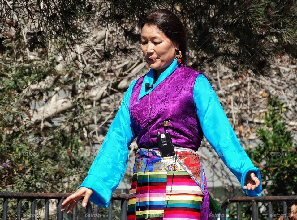 Tibetan Folk Singer. Woman In Traditional Tibetan Costume Performing Folkloric Dance