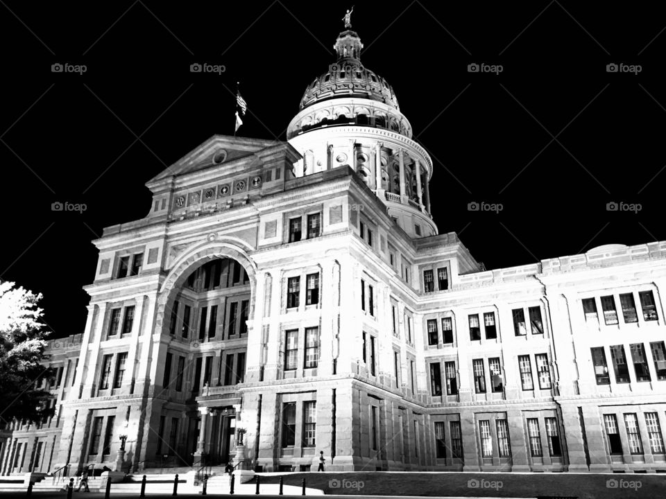 Black and white night photo of the Texas State Capitol in Austin, Texas.