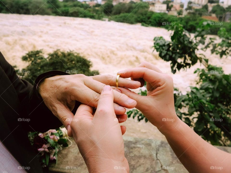 Wedding Ring exchange at the Piracicaba River, beautiful details of the groom and bride hands. True Love Captured