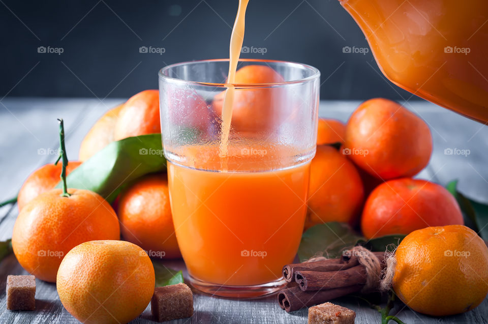 Orange juice pouring in glass