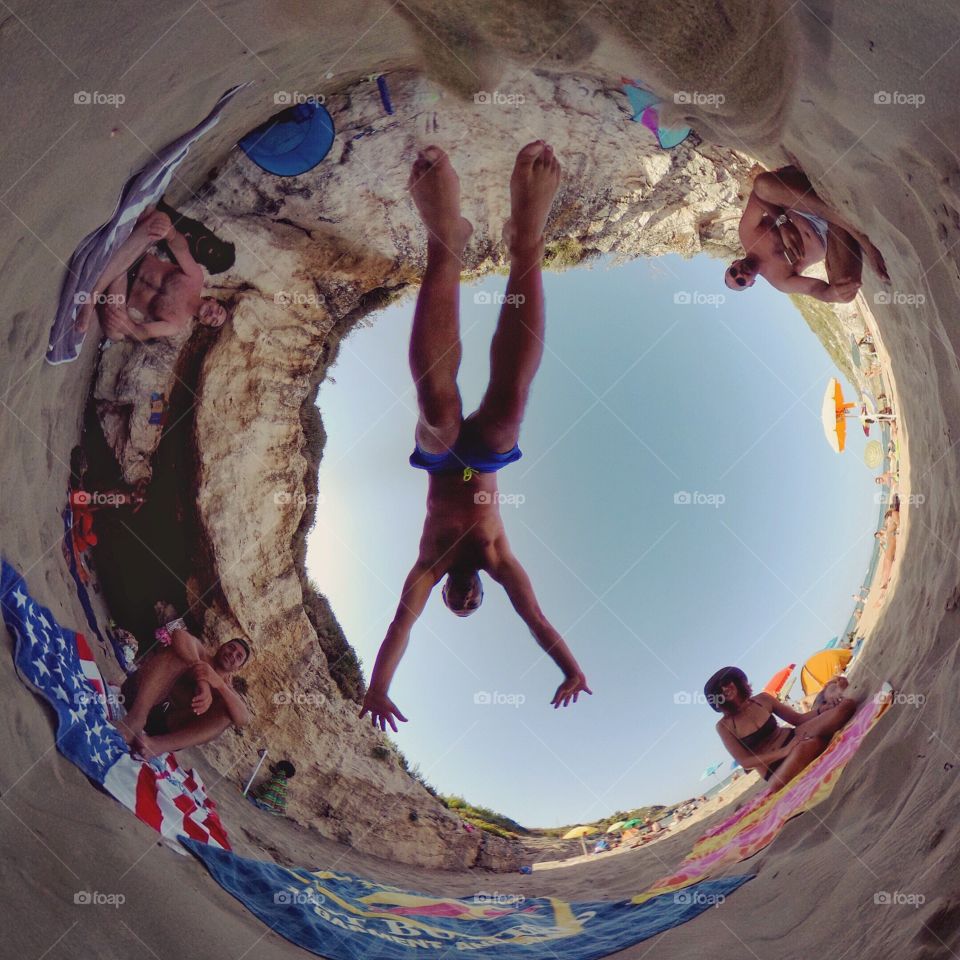 Tourists at beach seen through fish eye lens