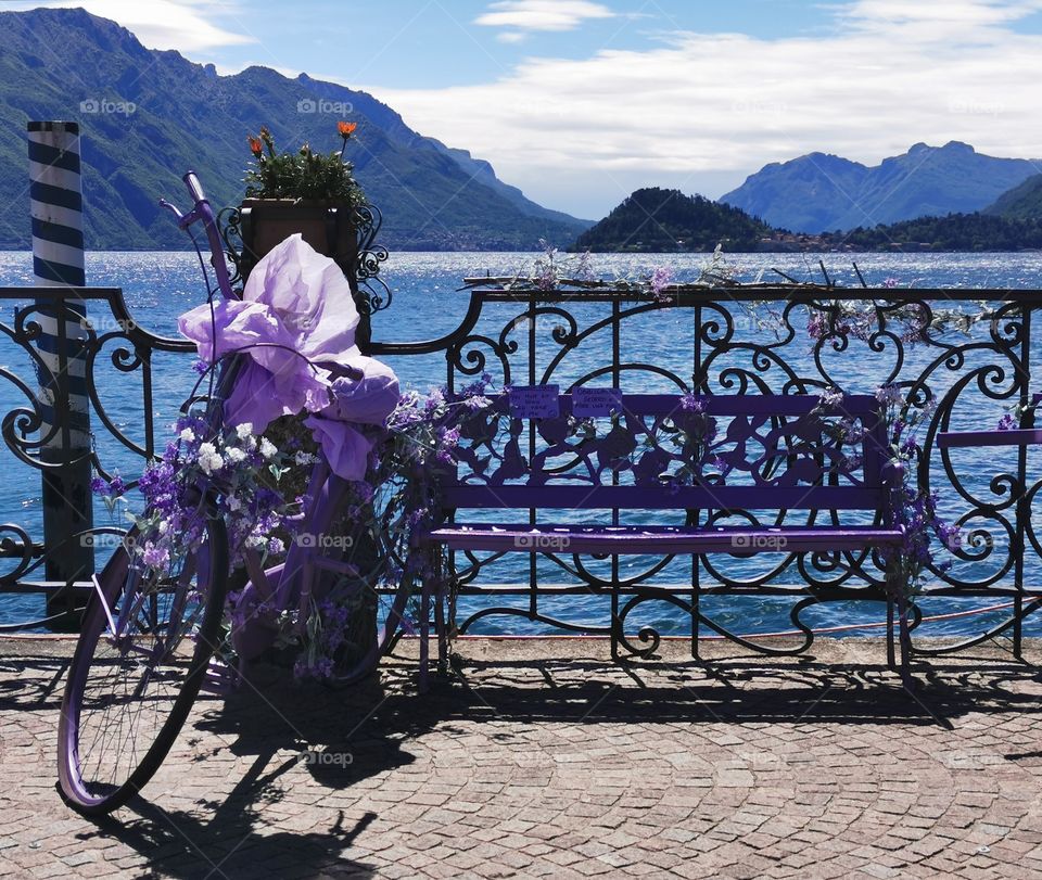 Beautiful purple decoration bicycle and bench Lake Como, Italy.