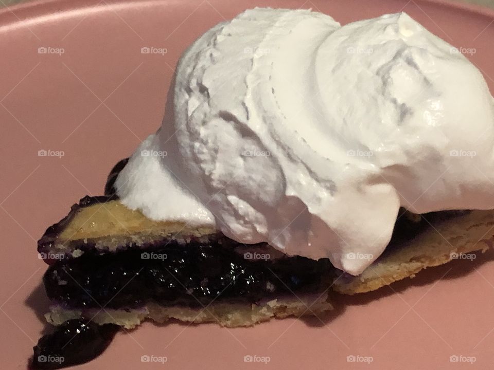 Blueberry pie with lots of whip cream