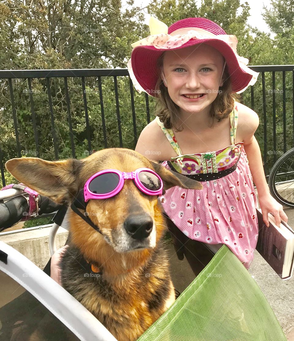 Pink hat girl with dog wearing pink googles - summer fun