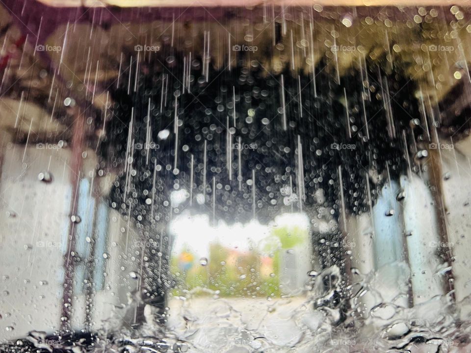 View from the car as the car wash sprays water onto the windshield. The exit is visible and sunny.