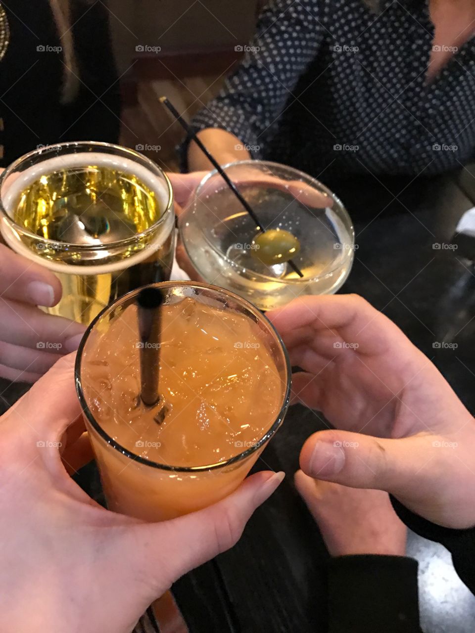 Enjoying drinks during holiday celebration with friends 