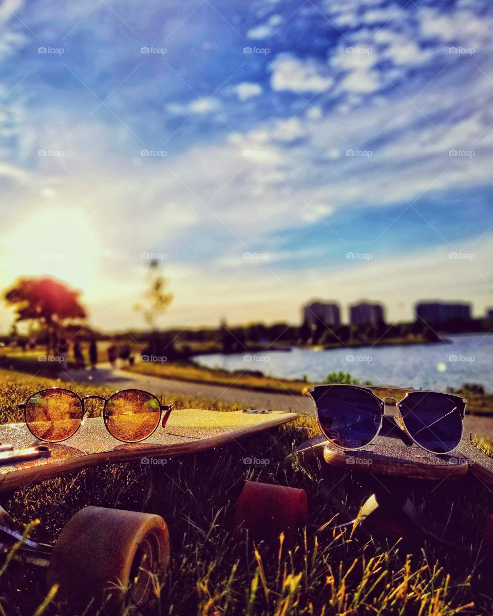 sunglasses on longboards by the bay