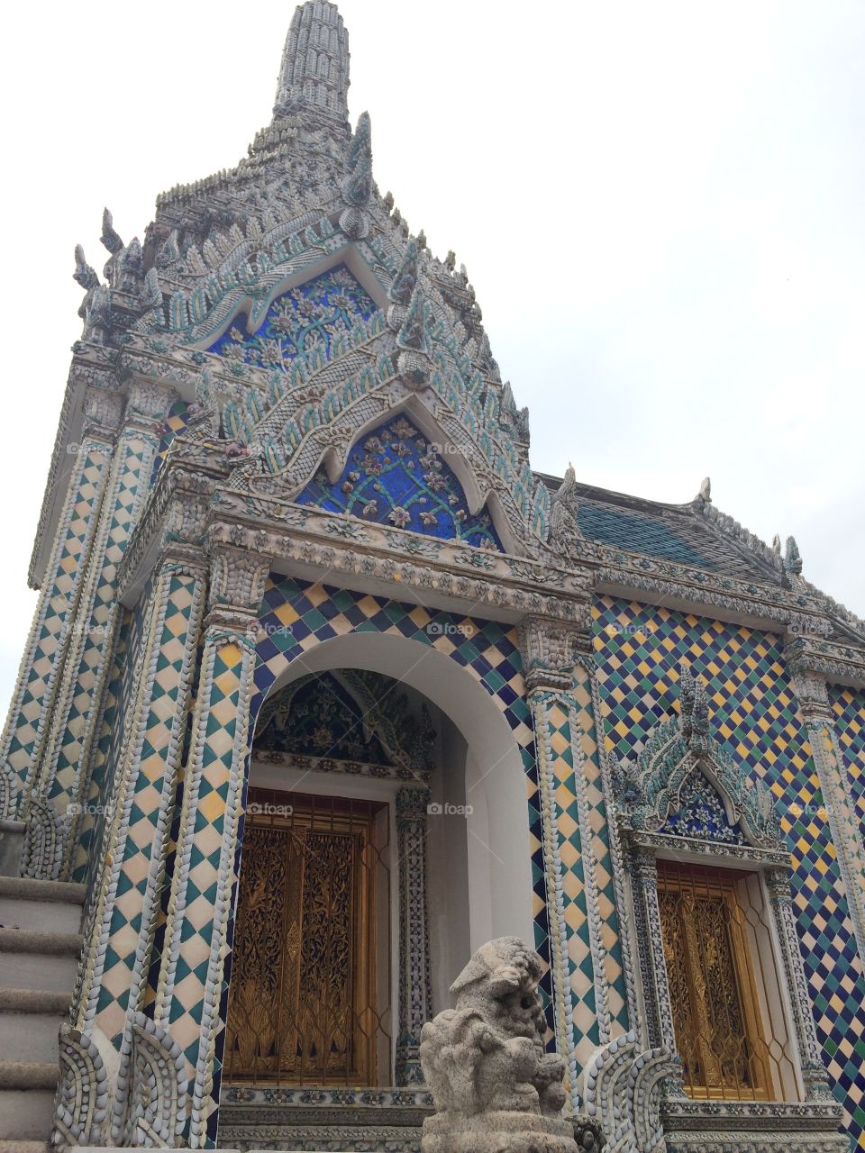 Bangkok, Thailand: Grand Palace temple with blue and yellow tiles and wooden doors