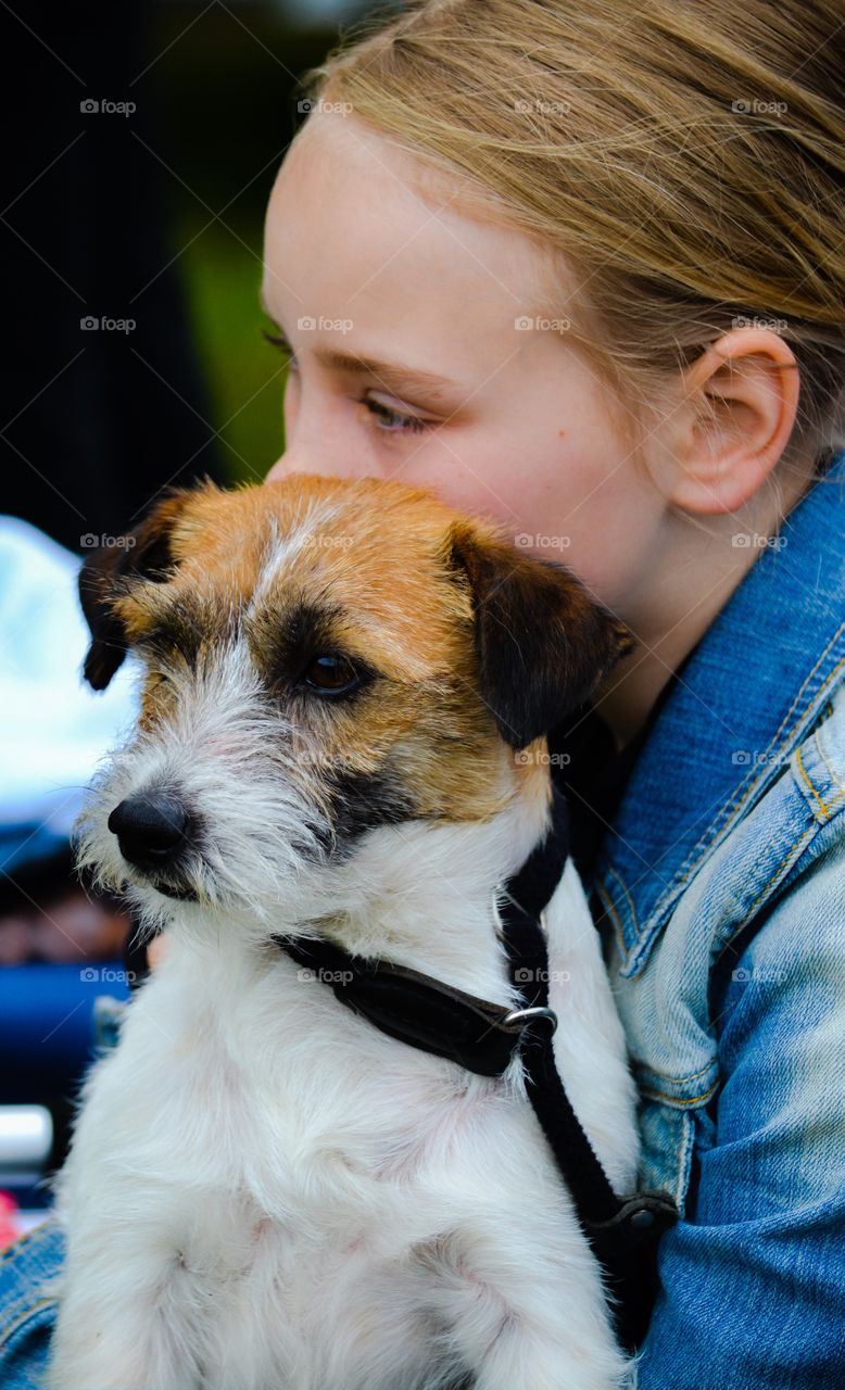 Girl and dog. Girl with a jack russell in her lap