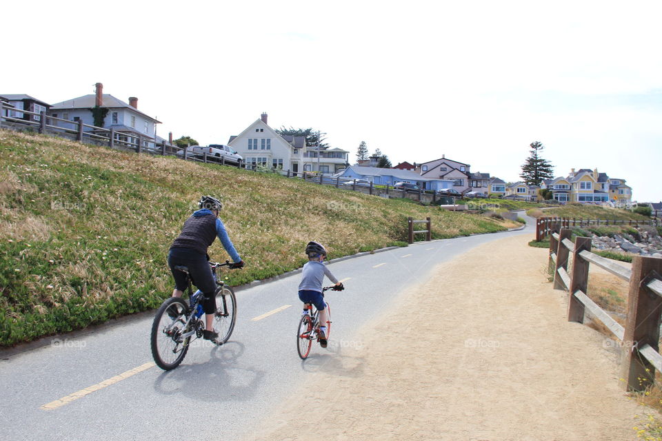 Adult and child riding bicycles 