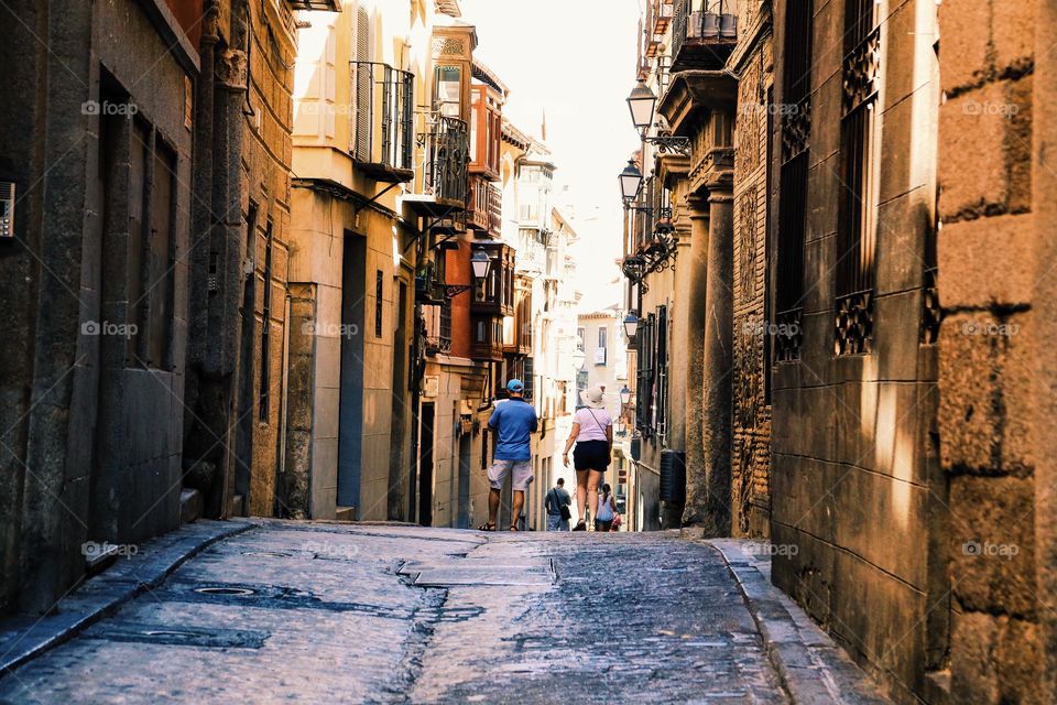 People from behind walking the streets of Toledo 