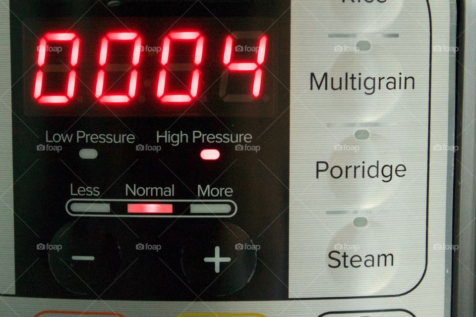 Closeup of an LED panel showing time setting on an electric pressure cooker at high pressure