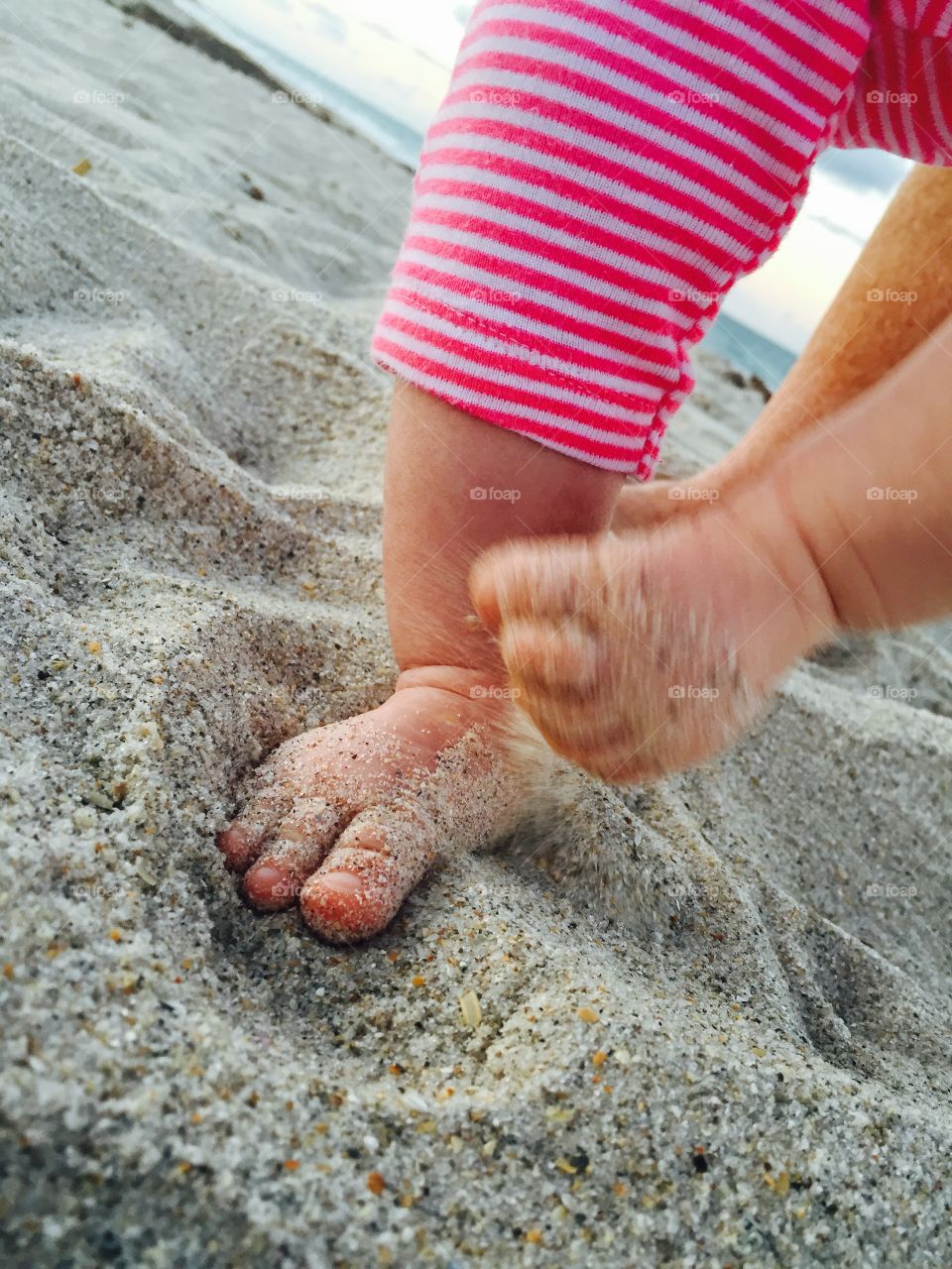 Baby feet. A baby walking in the sand