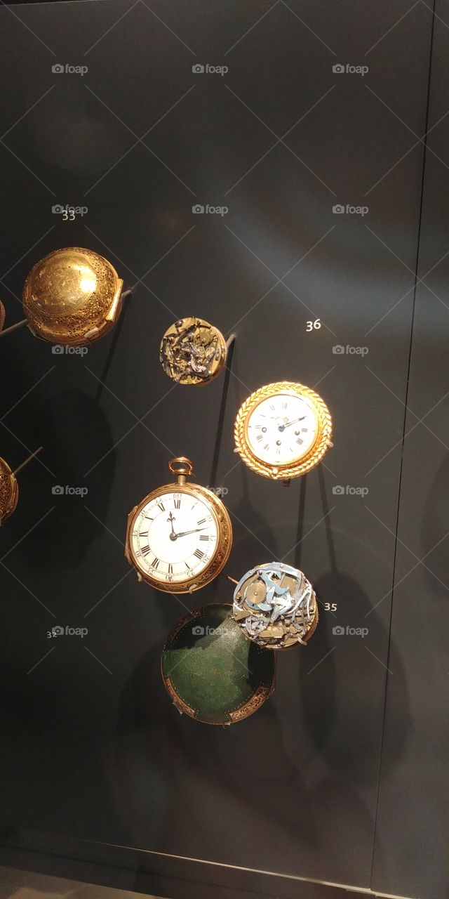 selection of pocket watches in museum display case