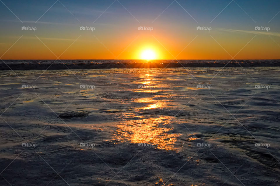 Close up surface of water in the ocean during sunset 