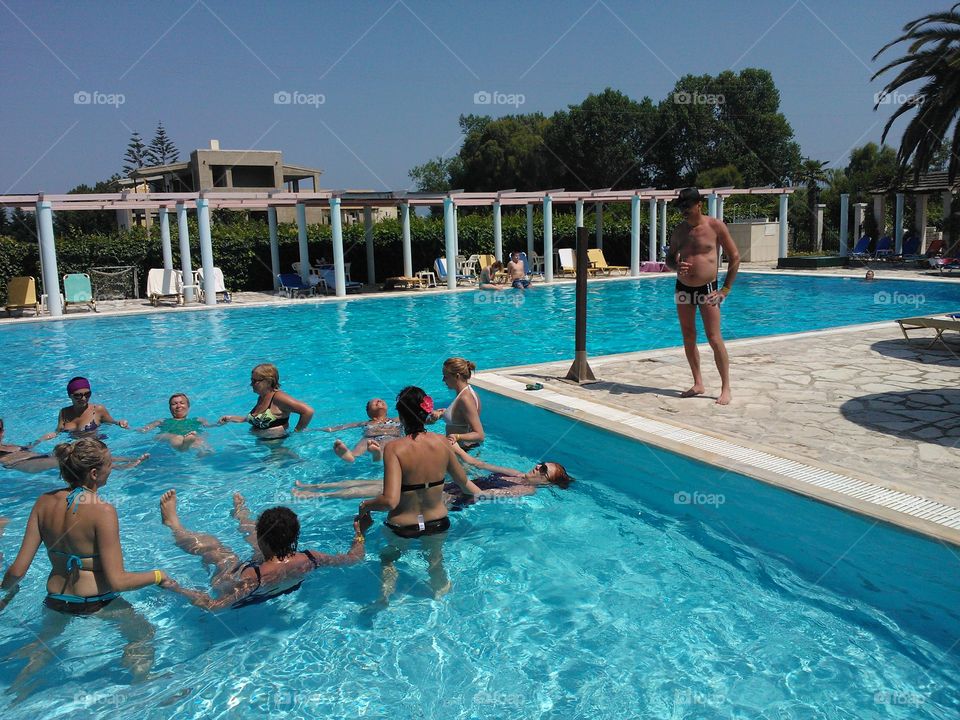 Man looking at women enjoying in the swimming pool