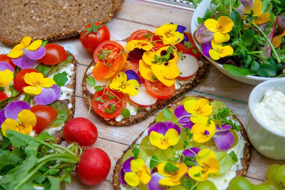 Healthy sandwiches with vegetables and edible flowers 