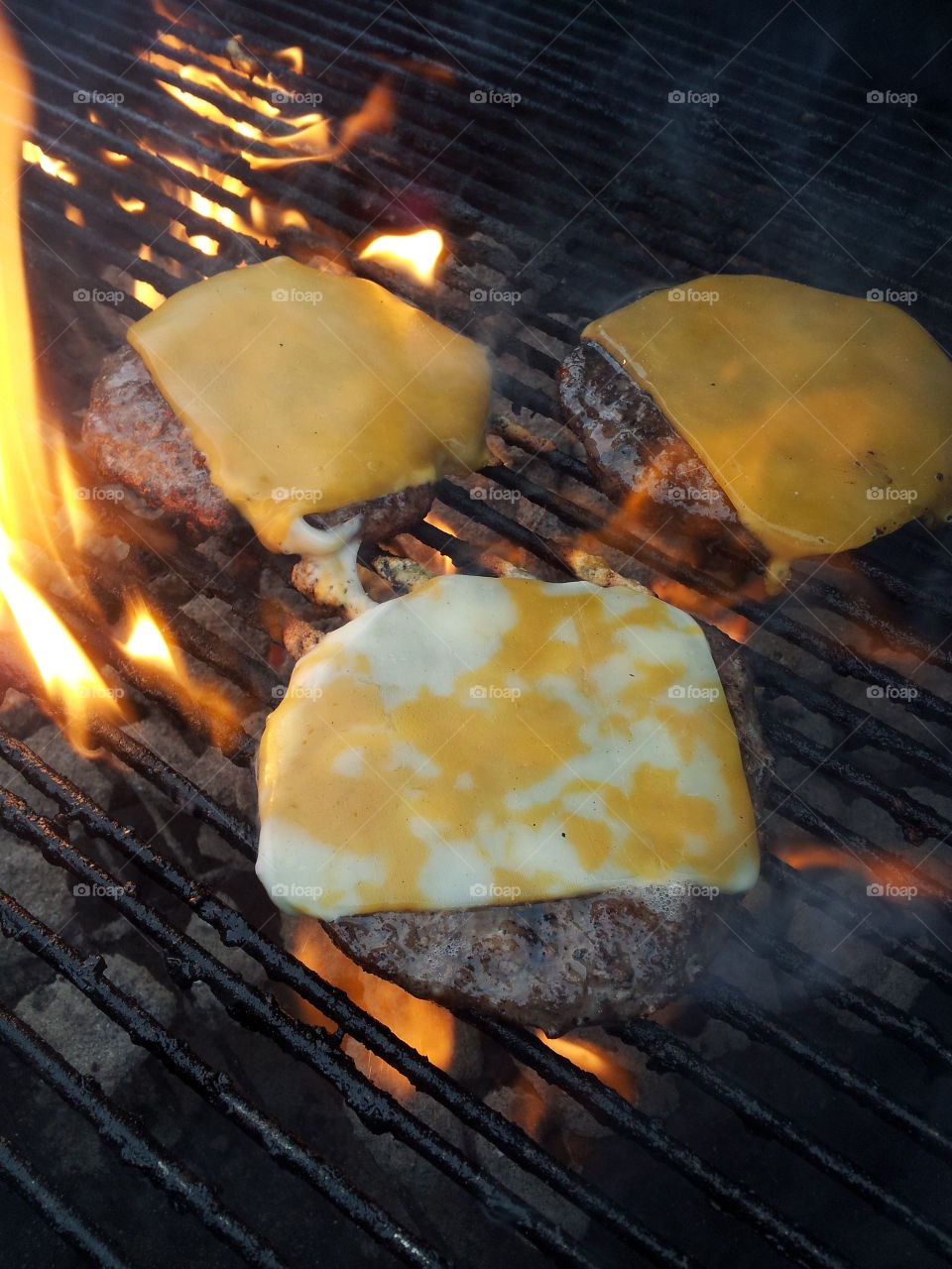 Flame kissed cheese burgers on the grill