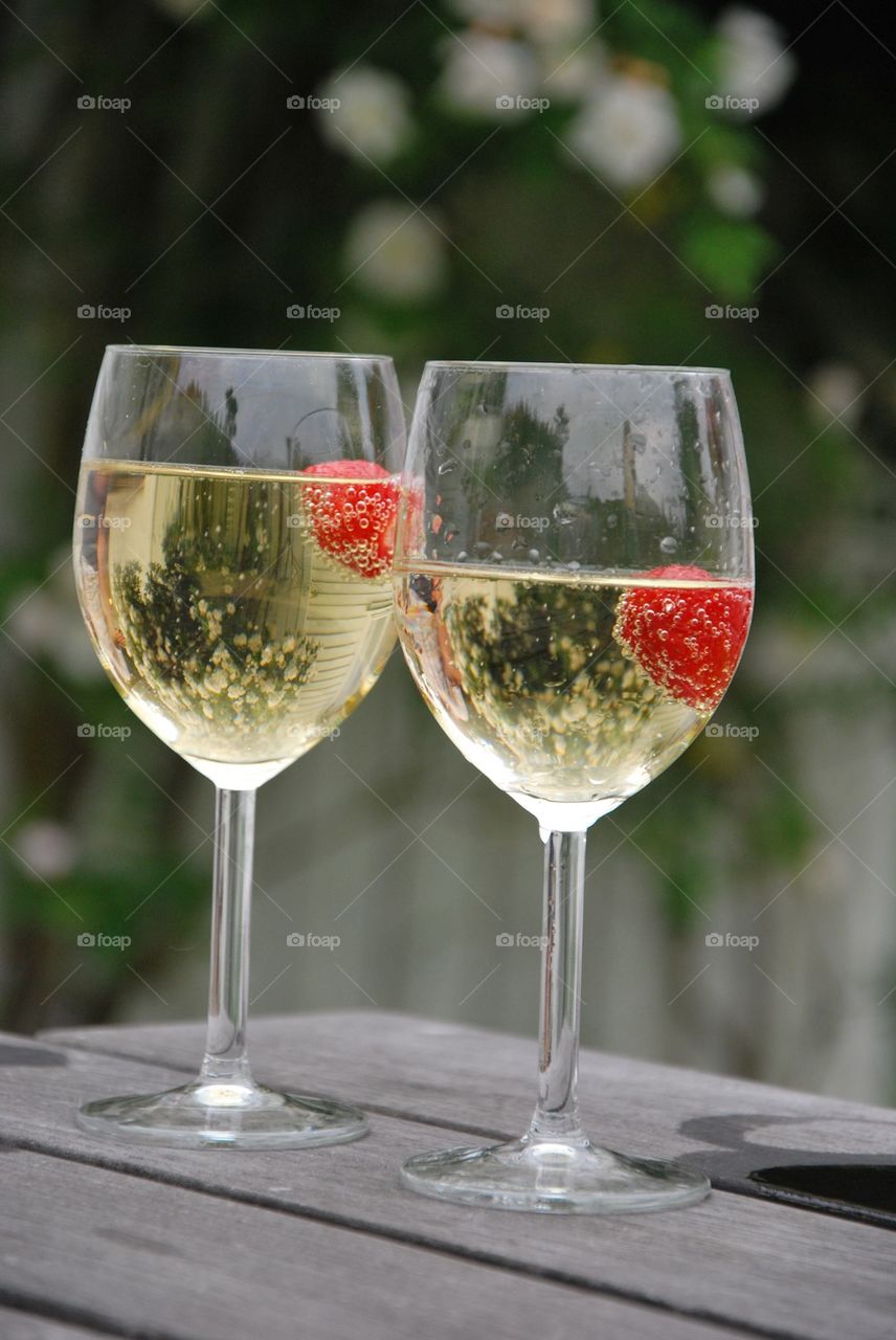 Wine with strawberries in wineglasses