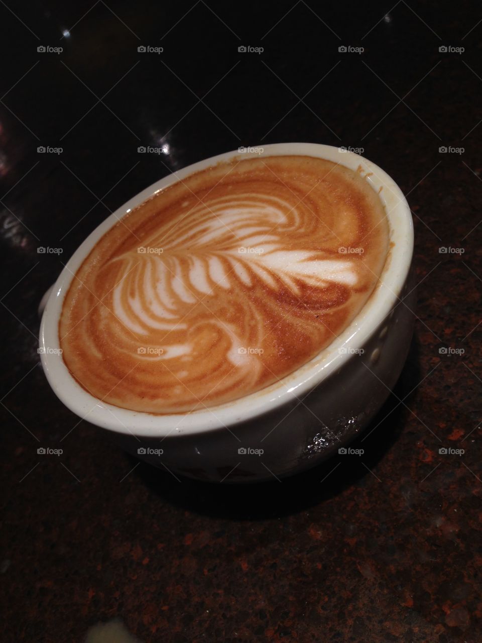 Flat White. Speciality coffee with leaf pattern 