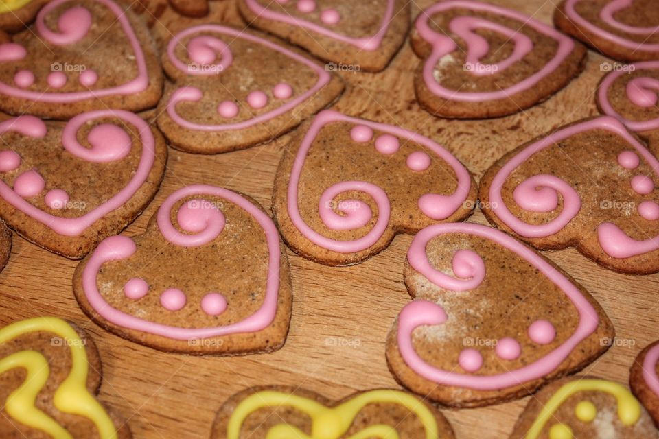 cookies. Pink gingerbread hearts on a wooden background