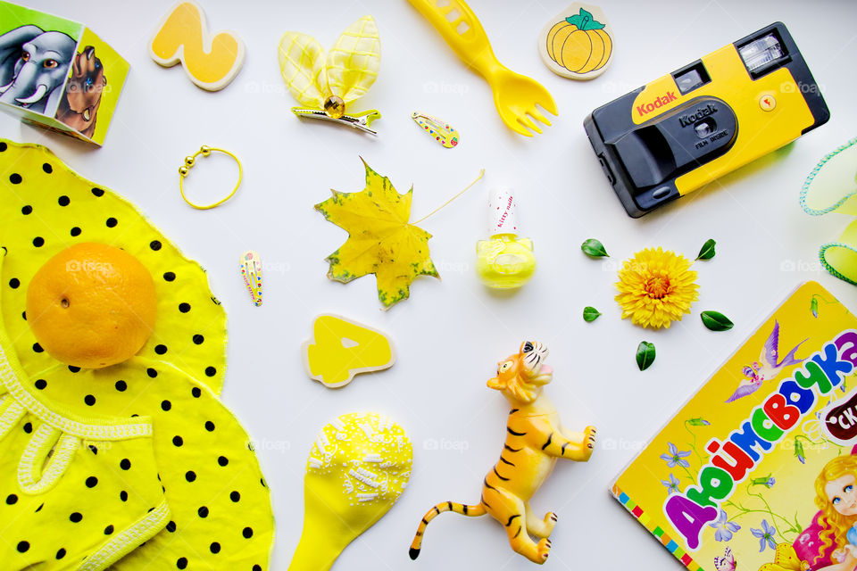flat lay item of yellow things and toys