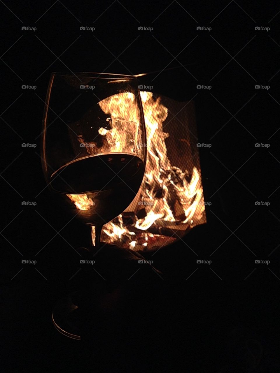 Glass of wine in front of Bon fire