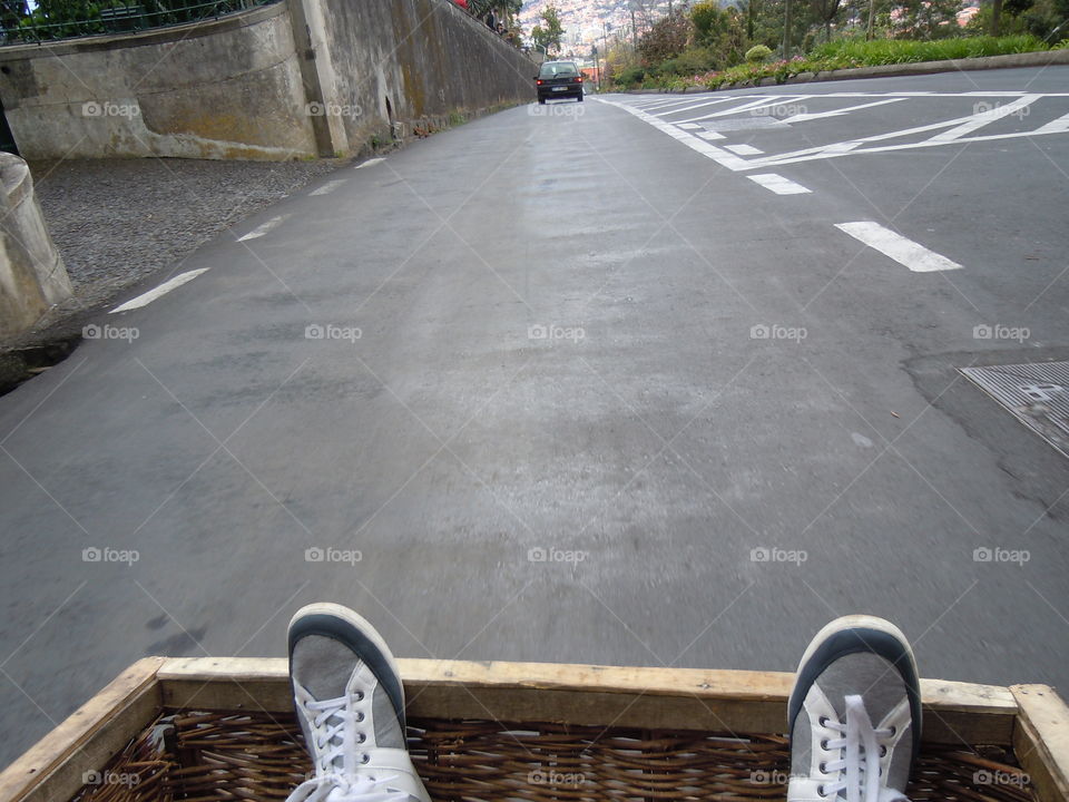 Down we go. My feet pictured in sledge on rd to funchal. Great fun very steep