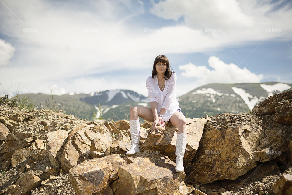 Young woman sitting on the rock