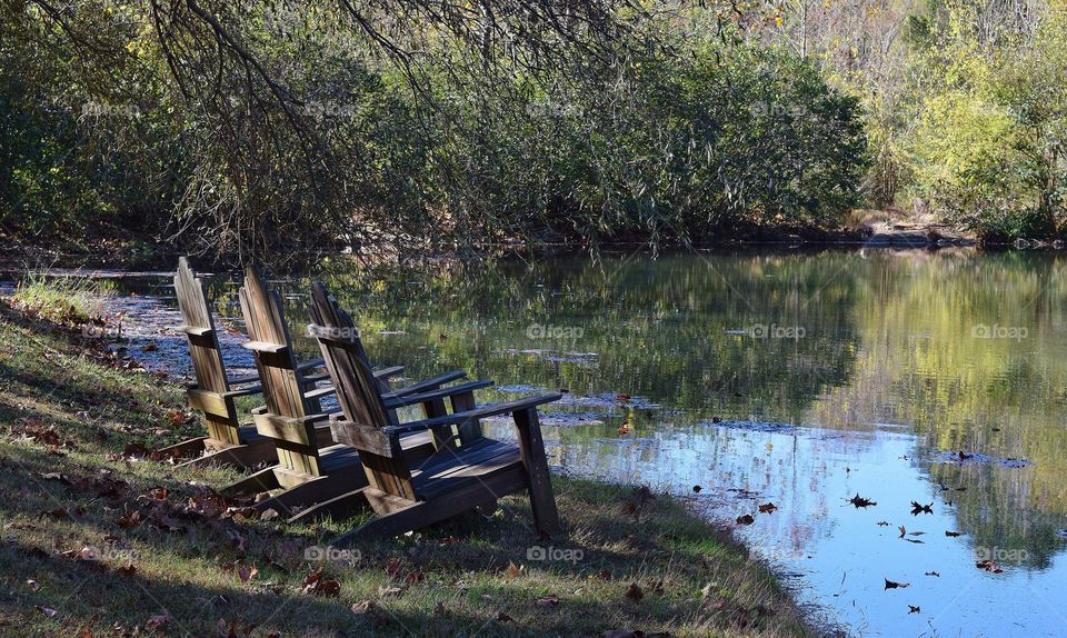 Adirondack chairs by a lake