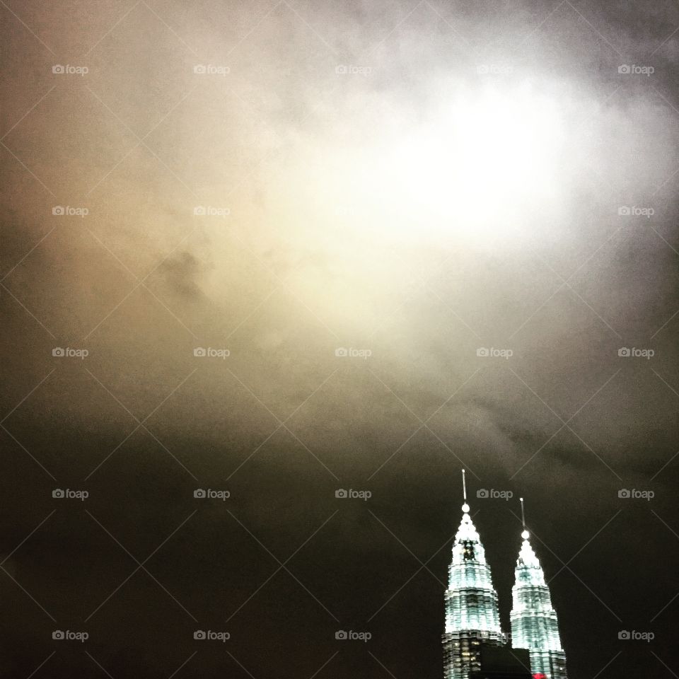 Kuala Lumpur. Twin Towers illuminating the storm clouds 