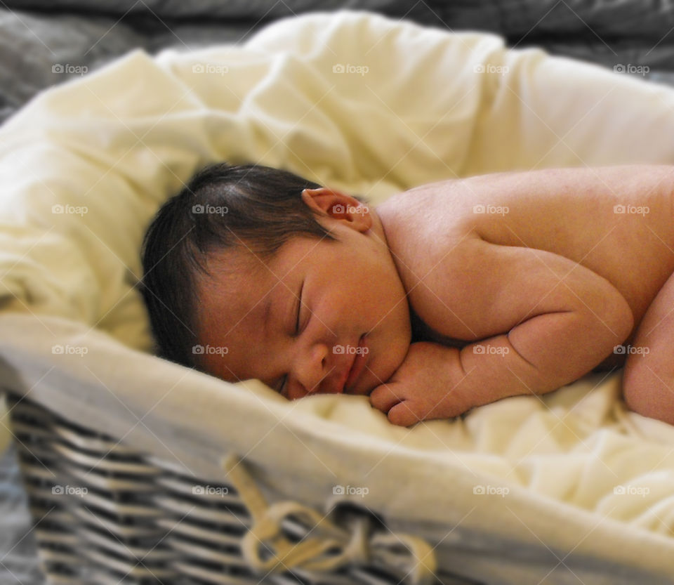 smiling newborn. tiny newborn grins while sleeping