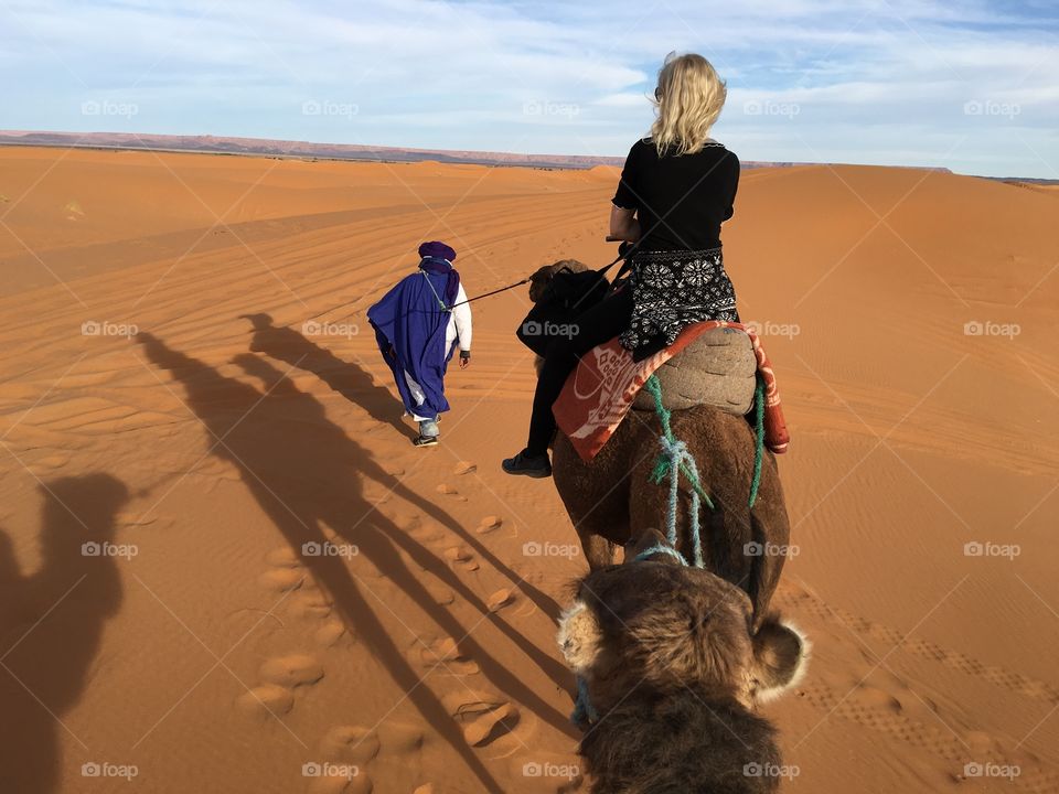 Caravan in Sahara at sunset 