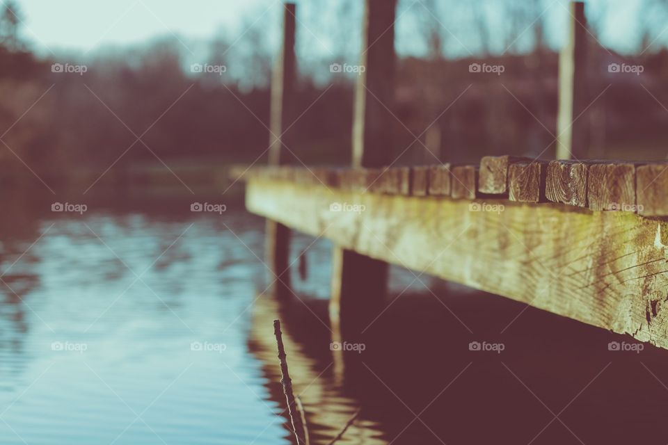 Cool perspective view of a dock looking out onto a beautiful lake.
