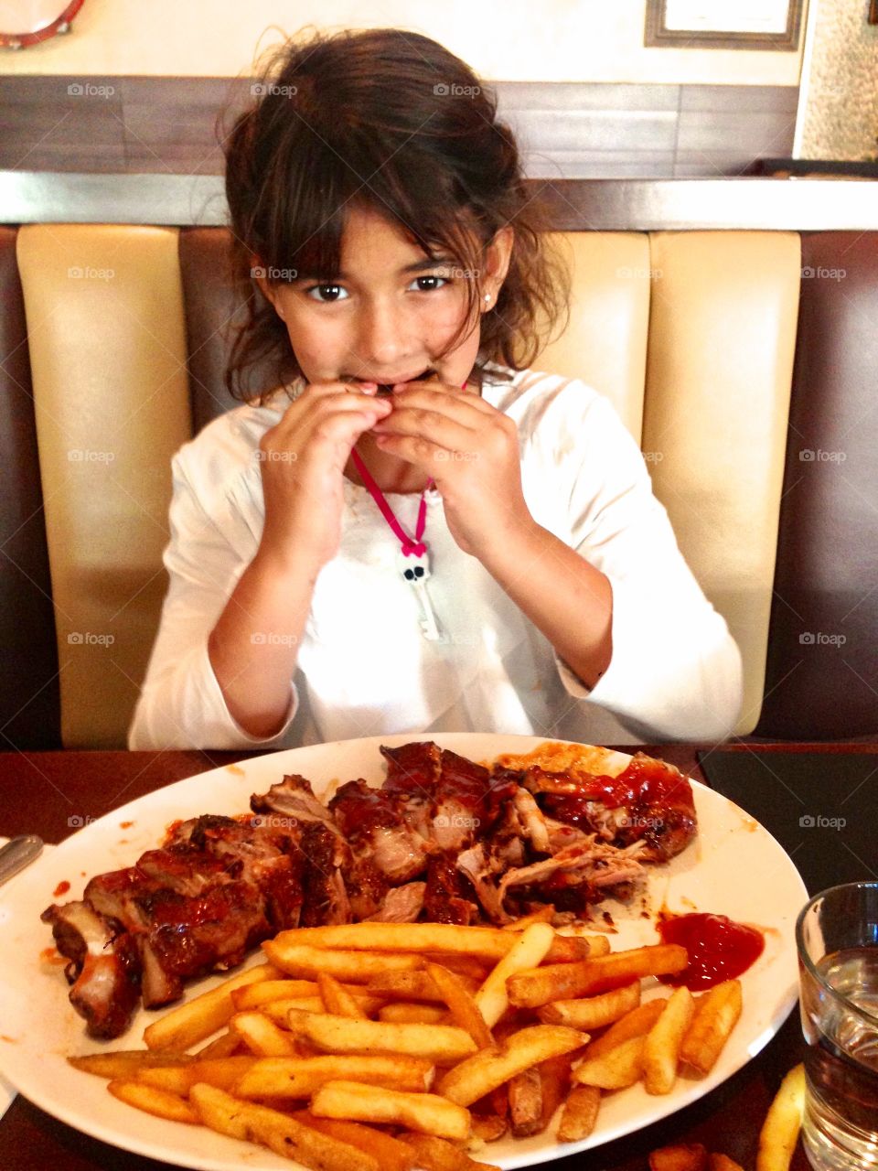 Girl eating food in restaurant