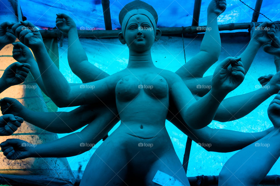 Handmade clay model of "Maa Durga" or " Devi Durga"- Hindu woman Idol close up. Snapped in the beginning of city famous Bengali festival of Kolkata or Calcutta, West Bengal, India, Asia