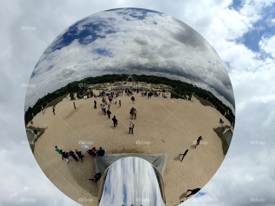 Sky Mirror at Versailles. Taken during a trip to the Palace at Versailles. The Sky Mirror is the work of Anish Kapoor. I'm in the white top.
