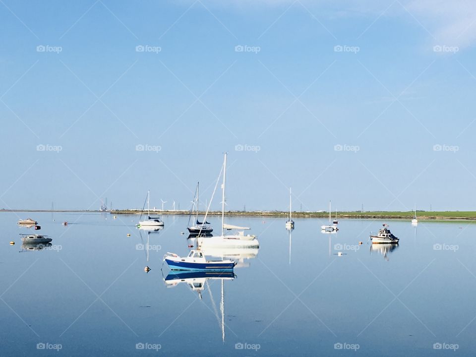 A beautiful view, a serene picture. Gorgeous spring day, fabulous sailing boats, love the reflection, symmetry and colour.