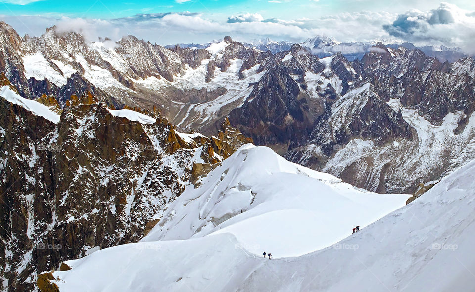 Group of alpinists mointainers walking at snow glacier slope in Mont Blanc, Chamonix, France.