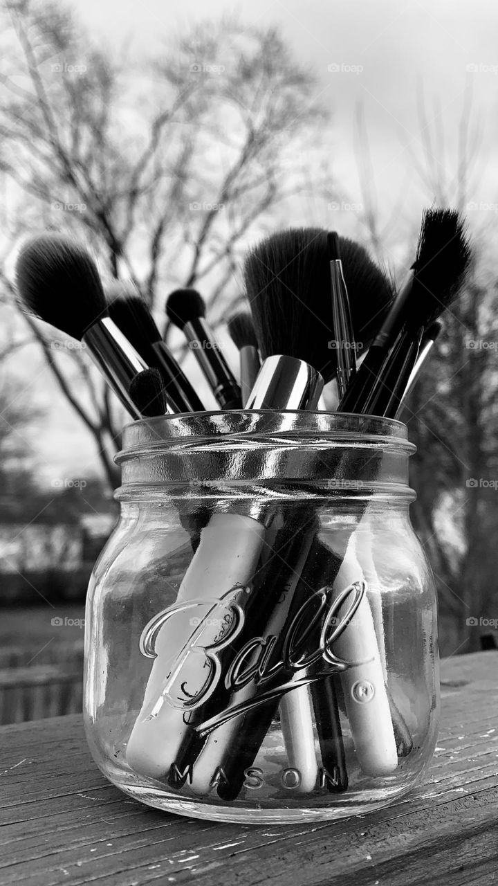 A sensible place to hold items you love. A glass jar fits so many things, including a variety of utensils. This mason jar holds makeup brushes. 