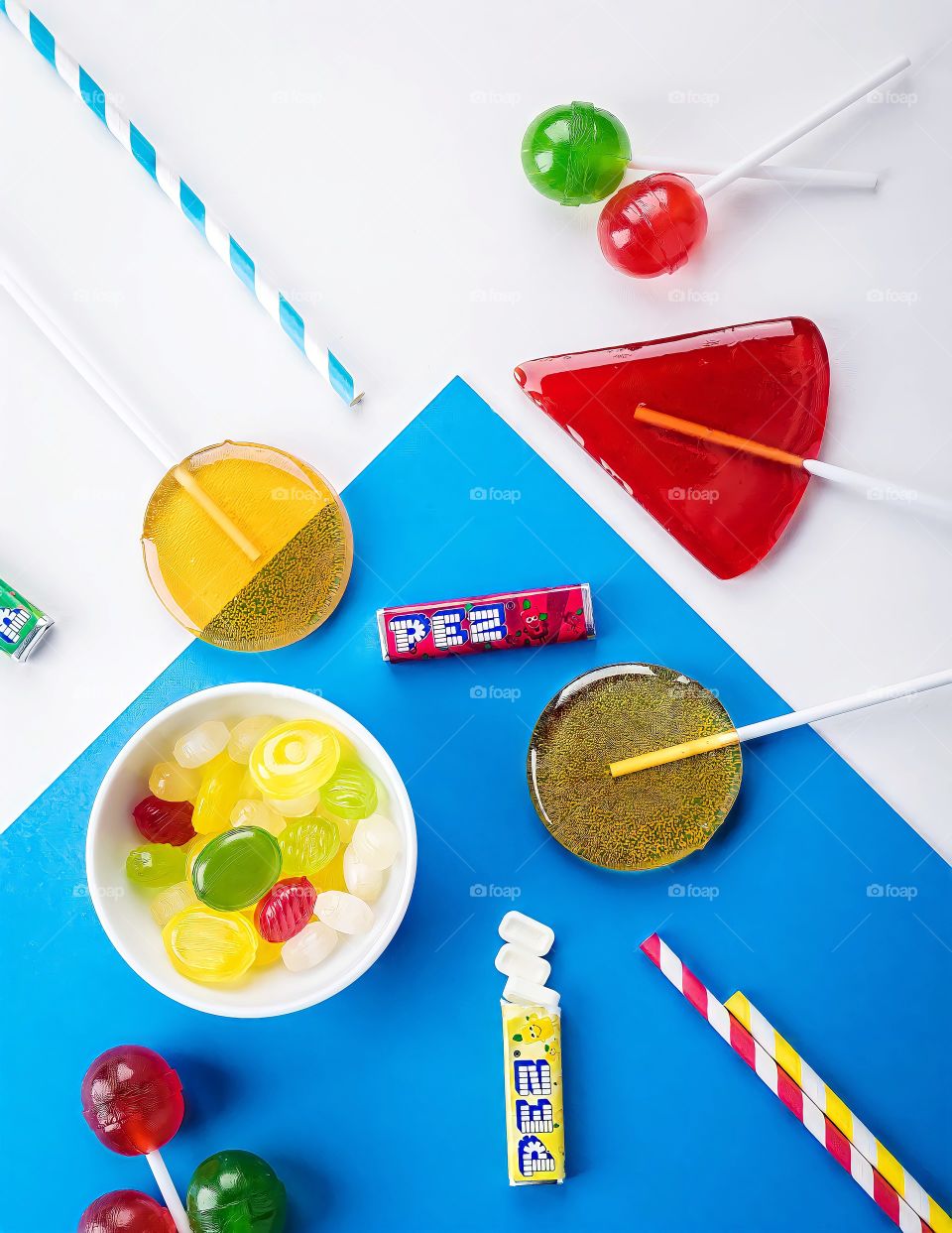 Lollipops and Candies
Lollipops with bowl of candies on white and blue background.